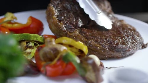 Juicy Cooked Steak with Roasted Vegetables on Plate