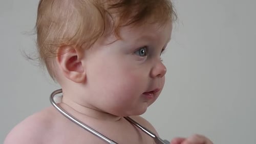 Close Up of Baby Wearing a Stethoscope