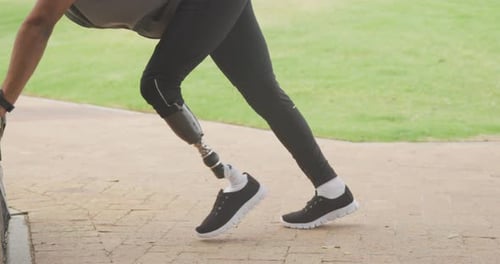 Man with Prosthetic Leg Doing Push-Ups in Park