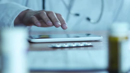 Typing on Tablet Pc and Pills in Hospital