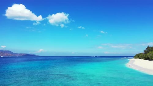 paradise beach of the Bali islands. White sand and palm trees Indian blue ocean.