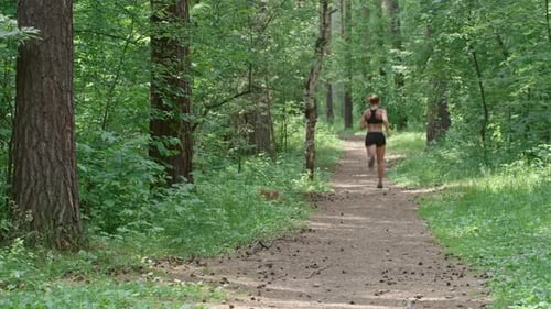 Young Athlete Jogging in Forest