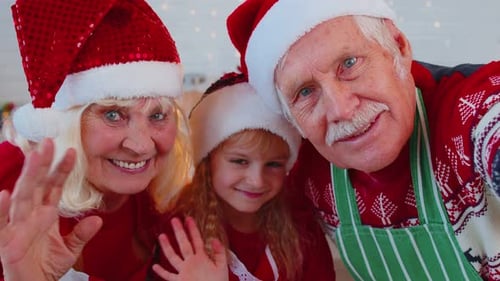 Grandparents and Grandchild Wearing Santa Hats
