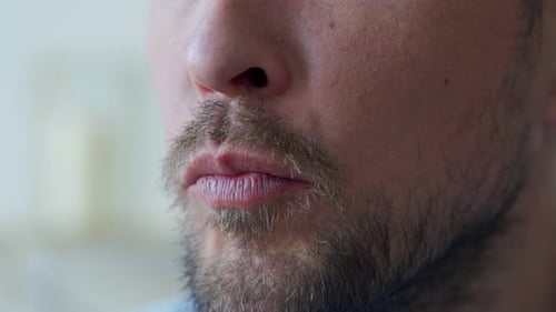Close Up of the Mouth of a Man Eating Potato Chips