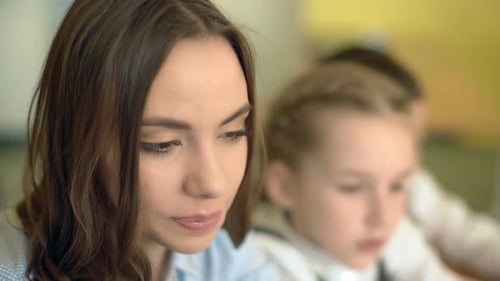 Woman Teaching Students in Classroom Setting