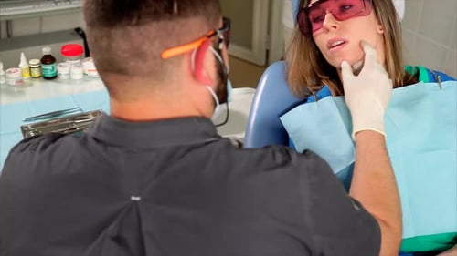Dentist Attending to Patient in Examination Room