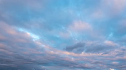 Pink Clouds Time-Lapse Across Soft Blue Sky