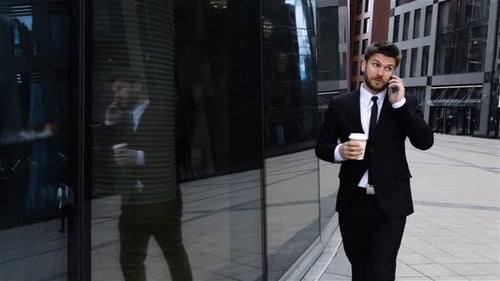 Businessman Talking on Mobile Cell Phone in City. Urban Male Professional Drinking Coffee.