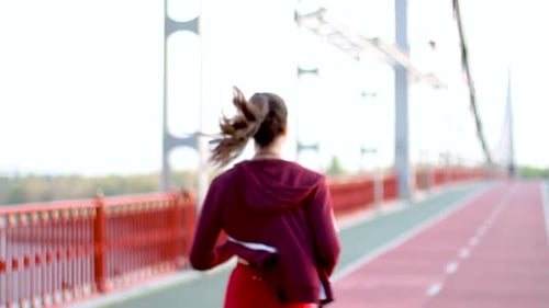 Woman Jogging Along Foot Bridge, Healthy Living