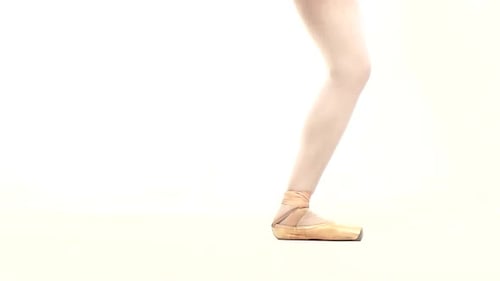 Ballerina Dancing on Toes in Gold Ballet Shoes
