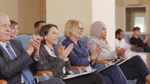 Audience Members Clapping at a Corporate Conference