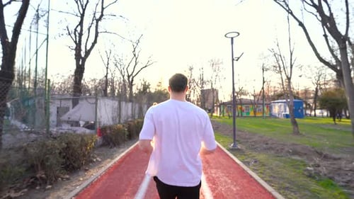 The athlete is running in the park.