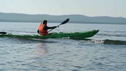 Kayaking Man on Waving Lake