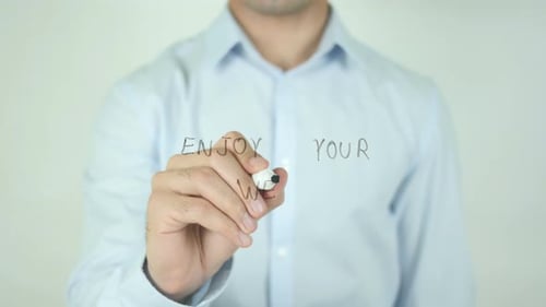 Man Writes Enjoy Your Week Message on Glass