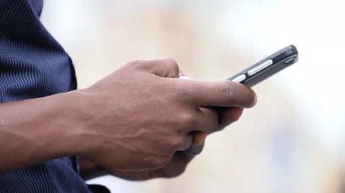 Adult Hands Using Mobile Phone, Close Up