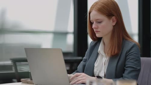 Serious Female Lawyer is Working with Laptop in Her Office Specialist of Legal Department in Modern