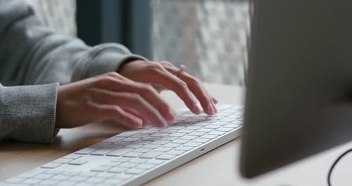 Woman type on desktop computer