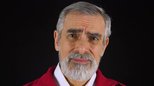An Elderly Man Looks at the Camera with Sadness - Face Closeup - Black Screen Studio