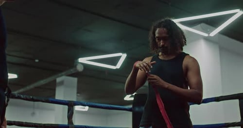 Athletic African Man is Wrapping Hand Before Fight in Ring in Sport Club Portrait Prores