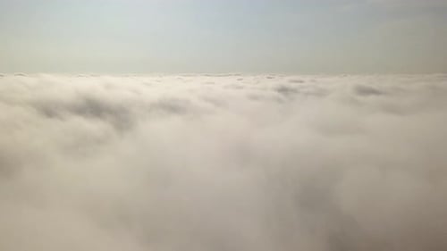 Fluffy White Clouds Drifting Under a Clear Blue Sky