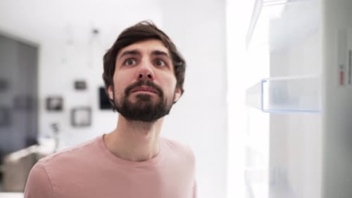 Man Opens Door of an Empty Fridge Surprised View From Inside