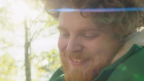 Loving Owner Petting Staffordshire Terrier Dog in Park