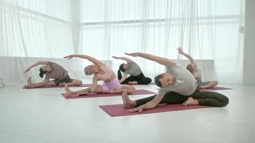 Yoga Class Group of Five Women and Man Exercising Healthy Lifestyle in In Bright Studio