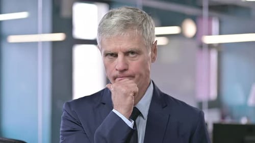 Pensive Businessman in Office Deep in Thought