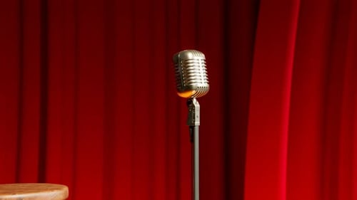 A vintage microphone on the empty stage. Old classic mic in the theatre. Show.