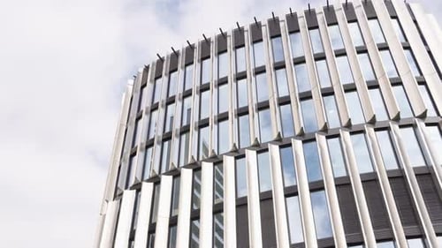 A Facade of a Windowed Office Building in an Urban Area on a Sunny Day
