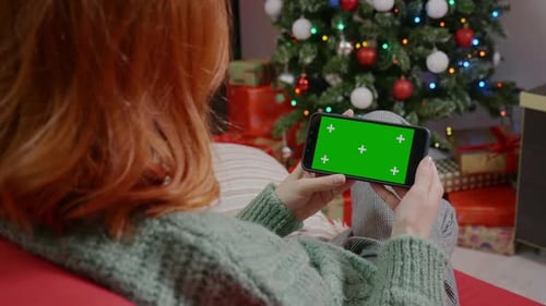 Pretty Woman holding Green Screen Chroma Key smartphone