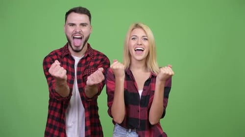 Excited Couple Celebrating Success Together