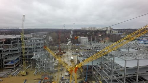 An Aerial View of a Huge Construction Site Against the Bare Forest and Dull Sky