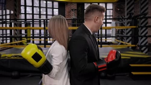 Confident Business People with Boxing Gloves Back-to-Back