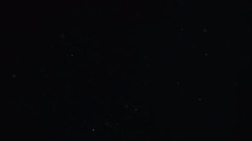 Abstract Particles Moving on Dark Background
