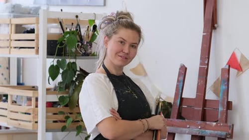 Young Adult Artist Stands in Art Studio