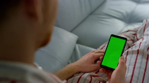 App User Holding Chroma Key Smartphone Closeup