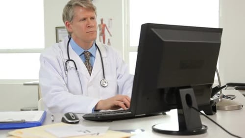 Doctor at desk working on computer