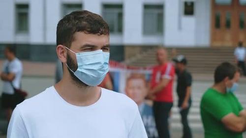 Man with Mask in Urban Setting