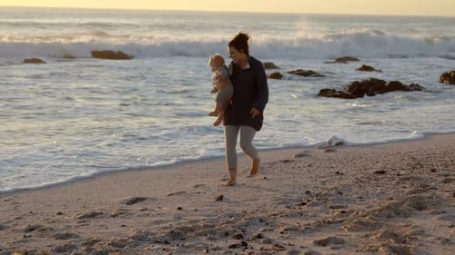 Mother and baby boy playing in the beach