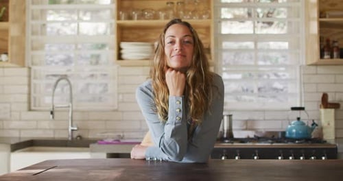 Woman Smiling in her Bright Home Kitchen