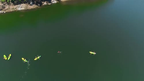 Aerial View of People Kayaking and Swimming in Lake