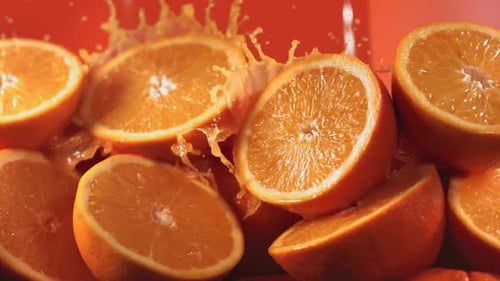 Orange Juice Pours Over Sliced Oranges
