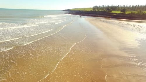 Woman horse riding on seashore