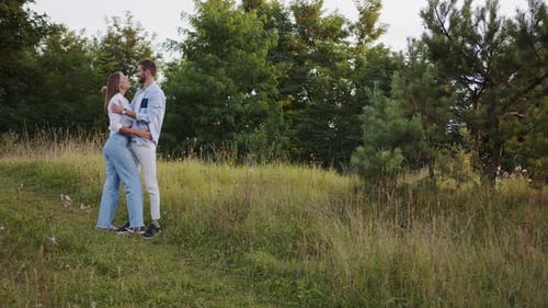 A Beautiful Girl and Boy Hugging in a Park