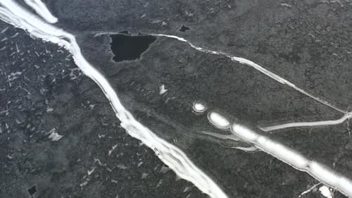 Frozen Lake High Up Drone View In Winter With Snow Trails 01