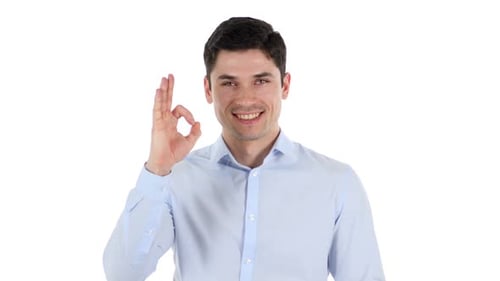 Man Smiling and Gesturing OK Sign on White