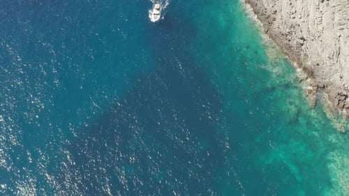 Top View of Sea or Ocean Waves Break on High Cliff of a Rocky Mountain