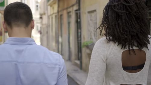 Multiethnic Couple Walking in Old European City