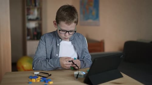 Boy Building Robotics Kit at Home